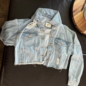 light blue ripped jean jacket